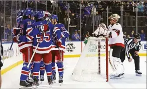  ?? Bruce Bennett / Getty Images ?? The Rangers celebrate a second-period goal by Chris Kreider (20) against the Senators’ Anton Forsberg (31) on Saturday at Madison Square Garden in New York.