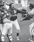  ?? ASSOCIATED PRESS ARCHIVES ?? Manager Dick Williams runs onto the field to celebrate with players after the A’s beat the Reds in 1972 World Series.