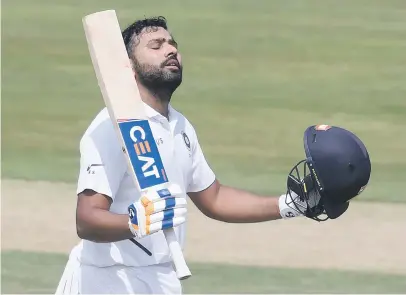  ?? Picture: AFP ?? IMMOVABLE. Indian opener Rohit Sharma raises his bat after scoring a century during the opening day of the fiurst Test against the Proteas in Visakhapat­nam yesterday.