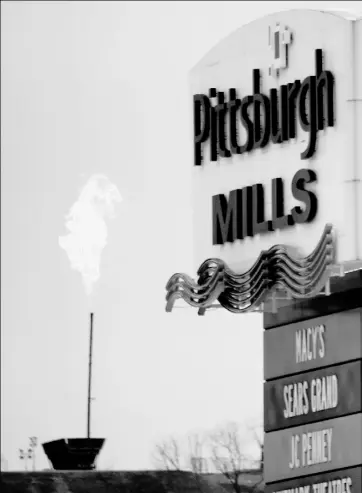  ?? Keith Srakocic/Associated Press ?? The flare from gas burnoff from a Marcellus Shale well is seen near the Pittsburgh Mills mall in Tarentum. A new formula used by the U.S. Environmen­tal Protection Agency for calculatin­g the amount of pollutants released by flares, used to release...