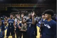  ?? ERIC BONZAR — THE MORNING JOURNAL ?? The Lorain Titans celebrate with the regional championsh­ip trophy after defeating Toledo St. John’s, 47-44.