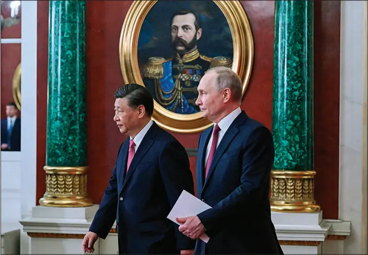  ?? GRIGORY SYSOYEV / SPUTNIK VIA AP ?? Chinese President Xi Jinping, left, and Russian President Vladimir Putin arrive for a signing ceremony Tuesday at the Grand Kremlin Palace in Moscow.