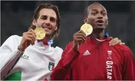  ?? Photograph: Patrick Smith/Getty Images ?? Joint gold medallists Gianmarco Tamberi (left) and Mutaz Barshim on the podium in Tokyo.