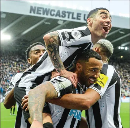  ?? ?? SPOT ON: Newcastle players celebrate with Callum Wilson as his penalty opens the floodgates at St James’