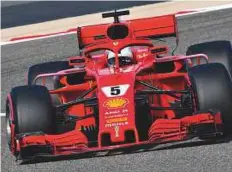  ?? AFP ?? Ferrari’s driver Sebastian Vettel steers his car during the practice session yesterday at the Sakhir circuit. The German will be joined by his teammate Kimi Raikkonen in the front row.