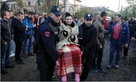  ??  ?? Emergency workers carry a woman in Thumanë. Photograph: Florion Goga/Reuters