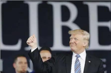  ?? PABLO MARTINEZ MONSIVAIS — THE ASSOCIATED PRESS ?? President Donald Trump acknowledg­es the crowd Saturday as he takes the stage to give the commenceme­nt address for the Class of 2017 at Liberty University in Lynchburg, Va.