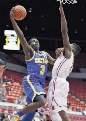  ?? Young Kwak Associated Press
By Zach Helfand ?? AARON HOLIDAY of UCLA shoots against Ike Iroegbu of Washington State in the first half.