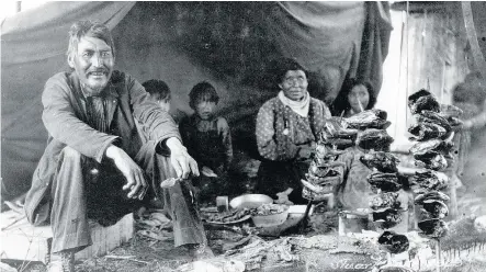  ??  ?? — SIMON FRASER B.C. ARCHIVES FILES Frank Swannell took this photo of indigenous British Columbians smoking salmon heads at Stuart Lake in 1909. It was among many new sights Swannell encountere­d as a surveyor.