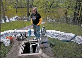  ?? CHRIS SWEDA/CHICAGO TRIBUNE ?? After a large amount of rain fell over the course of a couple of days, Charlie Eck checks on his sump pit Wednesday at his home on Woodland Avenue in Des Plaines.