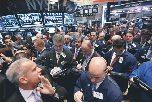  ?? (Brendan Mcdermid/reuters) ?? TRADERS WORK on the floor of the New York Stock Exchange last Friday. More than half of investors expect the Standard & Poor’s 500 Index to rise over the next six months.