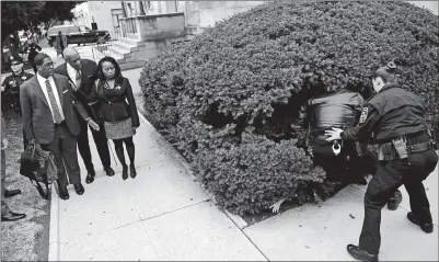  ?? COREY PERRINE AP PHOTO ?? A protester is detained as Bill Cosby, center left, arrives with spokespers­on Andrew Wyatt, left, and publicist Ebonee Benson, for Cosby’s sexual assault trial at the Montgomery County Courthouse Monday in Norristown, Pa.