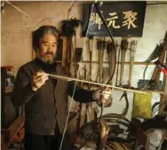  ?? FREDERIC J. BROWN/AFP/GETTY IMAGES ?? Yang Fuxi is said to be China’s last known traditiona­l bow and arrow maker. The craft was one of the six “noble arts.”