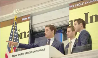  ?? — AFP ?? Snap Inc co-founder Bobby Murphy(L) with CEO Evan Spiegel (C) and NYSE President Thomas Farley, ring the opening bell at the New York Stock Exchange in New York.