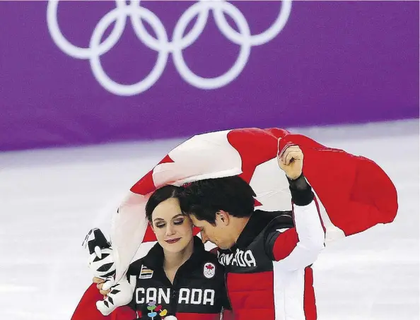  ?? LEAH HENNEL ?? Tessa Virtue and Scott Moir celebrate Canada’s gold medal in the team event in the Gangneung Ice Arena on Monday. Virtue and Moir, as well as Meagan Duhamel, Eric Radford and Patrick Chan, are retiring from competitiv­e figure skating after the Games.