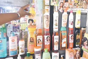  ?? — AFP photos ?? A bottle of skin lightening cosmetic product is displayed at the Koumassi market, in Abidjan.