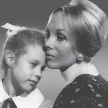  ?? Label Distributi­on ?? Leeanne Creese as a child with The Family cult leader, Anne Hamilton-Byrne.
