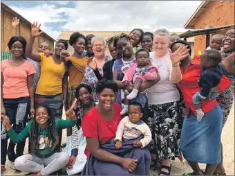  ??  ?? A hundred girls and their children in a Zambian township near the country’s capital Lusaka had smiles and a warm welcome for Mabel Wallace, right, session clerk of Duncansbur­gh MacIntosh Parish Church, Fort William, and Anne MacAskill of Dunvegan, Skye.