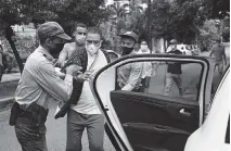  ?? YAMIL LAGE AFP vía Getty Images ?? A protester is detained at El Quijote Park in Havana, Cuba, where opposition figure and playwright Yunior Garcia was expected to protest, on Nov. 14.