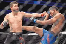  ?? JOHN LOCHER/ASSOCIATED PRESS ?? Carlos Condit, left, throws a punch at Neil Magny during their fight in December. Condit, who lost that fight, returns to the octagon tonight to face Alex Oliveira.