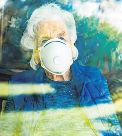  ??  ?? Uncertain times:
a care home resident gazes thoughtful­ly through the window