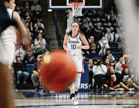  ?? Jessica Hill/Associated Press ?? UConn’s Nika Muhl runs backward after breaking UConn’s single-season assist record held previously by Sue Bird in the first half against Xavier on Monday in Storrs.