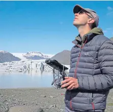  ??  ?? Dr Kieran Baxter flies a drone over the ice.