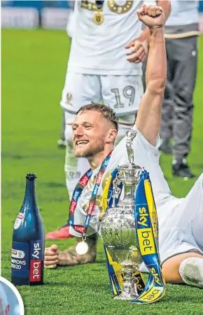  ??  ?? Liam Cooper celebrates Leeds United’s title success, and has mpressed club legend, Eddie Gray (inset)