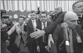  ??  ?? Italy's populist Five Star Movement (M5S) party leader Luigi Di Maio (C), is surrounded by bodyguards as he arrives at a press meet a day after Italy's general polls, on Monday in Rome. AFP