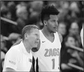  ?? Associated Press ?? TOP SPOT Gonzaga head coach Mark Few, left, speaks with guard Admon Gilder (1) during a game on Saturday. Gonzaga is the sixth team to hit No. 1 in the AP poll this season.