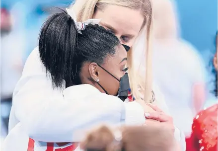  ?? WALLY SKALIJ/LOS ANGELES TIMES ?? Simone Biles is consoled after competing on the vault and withdrawin­g from competitio­n Monday at the Tokyo Olympics.