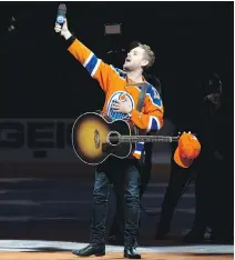  ??  ?? Brett Kissel reacts as fans at Rogers Place sing The Star-Spangled Banner, prior to the Oilers and Ducks game in Edmonton last Sunday.