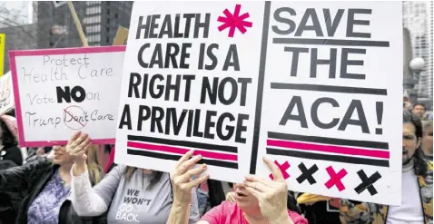  ?? CHARLES REX ARBOGAST / ASSOCIATED PRESS ?? Protesters gather across the Chicago River from Trump Tower to rally against the repeal of the Affordable Care Act last month in Chicago. Earlier, President Donald Trump and GOP leaders yanked their bill to repeal Obamacare off the House floor when it...