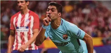  ??  ?? Barcelona’s Luis Suarez gestures towards Atletico Madrid fans as he celebrates scoring their first goal. REUTERS PIC