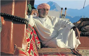  ?? iSTOCK ?? DRIFTING AWAY: A dhow captain takes five in Khasab, a port city on northern Oman’s Musandam Peninsula