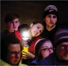  ?? JAKE MAY/THE FLINT JOURNAL VIA AP ?? Allison Hepp, 15, leans on her brother Benjamin Hepp, 17, as they stand alongside classmates during a prayer vigil at a church in Oxford, Michigan, on Tuesday after the Oxford High School shootings.