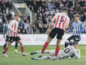  ?? ?? Sunderland’s Anthony Patterson saves at the feet of Wednesday’s Josh Windass.