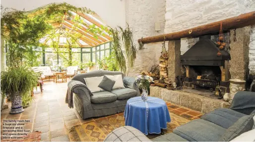  ??  ?? The family room has a huge old stone fireplace and a terracotta-tiled floor, and opens directly into a sunroom