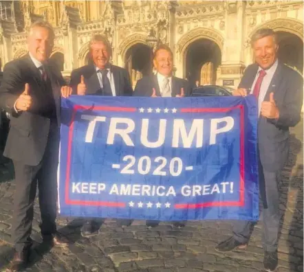  ??  ?? Banner drama: Ian Paisley (left), Sammy Wilson (second left) and Paul Girvan (right) with the Trump flag
