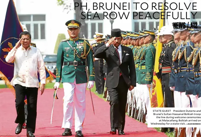  ?? —JOAN BONDOC ?? STATE GUEST President Duterte and Brunei’s Sultan Hassanal Bolkiah troop the line during welcome ceremonies at Malacañang. Bolkiah arrived on Wednesday for a state visit.