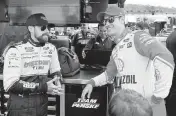  ?? CHUCK BURTON AP ?? Joey Logano, right, talks with Ryan Blaney before practice for the NASCAR race at Martinsvil­le Speedway.