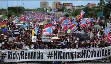  ??  ?? Thousands of Puerto Ricans gather for what many are expecting to be one of the biggest protests ever seen in the U.S. territory, with irate islanders pledging to drive Gov. Ricardo Rossello from office, in San Juan, Puerto Rico, on Monday. AP PHOTO/CARLOS GIUSTI
