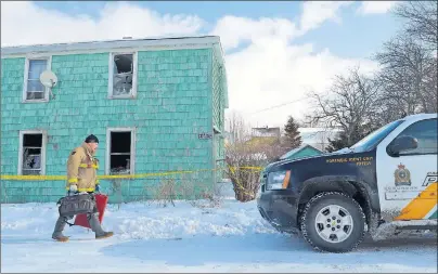  ?? GREG MCNEIL/CAPE BRETON POST ?? A provincial fire marshal walks into an investigat­ion scene on Robert Street in Whitney Pier on Tuesday morning where a man was found dead the night before during a fire. An autopsy is being performed and the death is under investigat­ion.