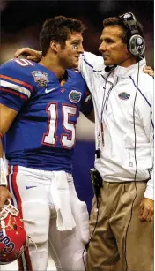  ??  ?? ORLAND SENTINEL Florida coach Urban Meyer and quarterbac­k Tim Tebow share a moment in the fourth quarter against Cincinnati in the 2010 Sugar Bowl.