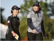  ?? Elizabeth Conley / Staff photograph­er ?? Sisters Moriya, left, and Ariya Jutanugarn of Thailand laugh after finishing the third round.