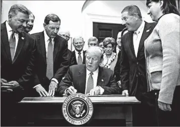  ?? ANDREW HARNIK/AP ?? President Donald Trump signs the Waters of the United States (WOTUS) executive order in this February 2017 photo.