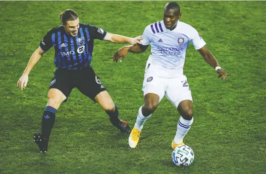  ?? EDUARDO MUNOZ ALVAREZ/AP ?? Orlando City defender Kamal Miller, right, battles Montreal Impact midfielder Samuel Piette during a November match. Miller has just joined the Impact.