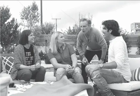  ?? TRAE PATTON ?? Host Paige Davis, left, a homeowner, designer Doug Wilson and carpenter Carter Oosterhous­e in the welcome reboot of Trading Spaces.