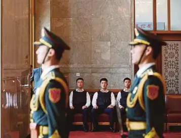  ?? PIC
AP ?? Security guards wearing bulletproo­f vests sitting at the Great Hall of the People before the meeting between Russian President Vladimir Putin and Chinese Premier Li Keqiang, on the sidelines of the Belt and Road Forum, in Beijing on Sunday.