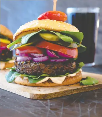  ?? PHOTOS: KAREN BARNABY ?? In toasted buns with lettuce, tomatoes and onions, Black Bean Burgers live up to what you probably want a bean burger to be. Never be disappoint­ed by a vegan burger again!